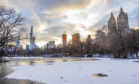 Winter view at Upper West Side cityscape buildings at sunset from Central Park New York City lakeの写真素材
