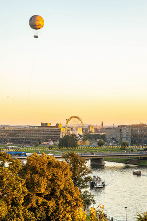 Scenic golden hour view of Krakow city center over Vistula river with hot air balloonのeditorial素材