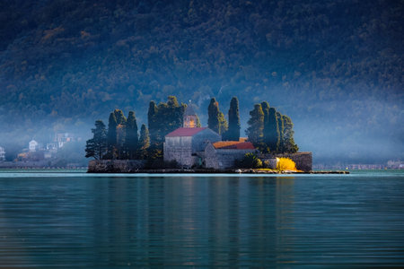 Scenic Saint George Monastery at sunrise in fog of Montenegroの写真素材
