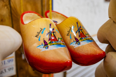 Close-up photo of traditional Dutch wooden shoes with colorful hand-painted designs sold as cultural souvenirsの写真素材