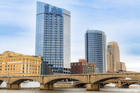Photo of Grand Rapids Michigan with modern skyscrapers and multiple bridges spanning the river through the downtown urban landscape.の写真素材