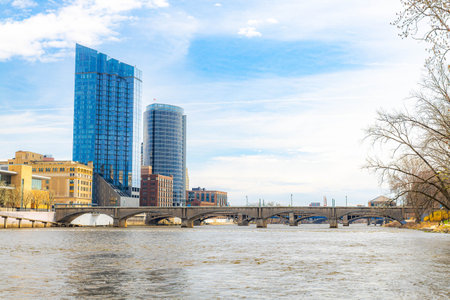 Photo of Grand Rapids Michigan with modern skyscrapers and multiple bridges spanning the river through the downtown urban landscape.の写真素材
