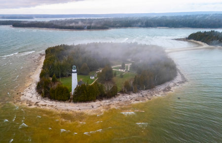 Dramatic aerial image of Cana Island Lighthouse in Wisconsin captured on a foggy day along Lake Michigan shorelineの写真素材