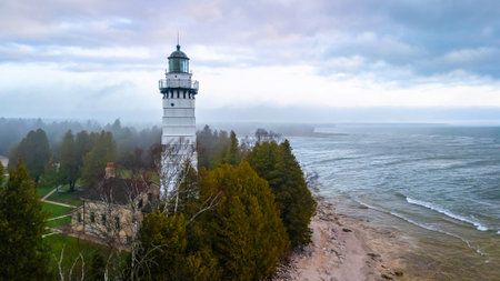 Dramatic aerial image of Cana Island Lighthouse in Wisconsin captured on a foggy day along Lake Michigan shorelineの写真素材