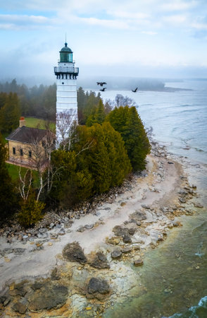 Dramatic aerial image of Cana Island Lighthouse in Wisconsin captured on a foggy day along Lake Michigan shorelineの写真素材