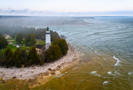 Dramatic aerial image of Cana Island Lighthouse in Wisconsin captured on a foggy day along Lake Michigan shorelineの写真素材