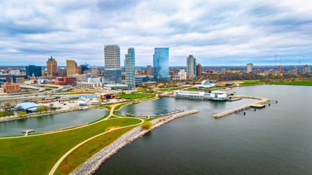 Milwaukee Wisconsin city skyline with modern skyscrapers captured from Lakeshore State Park along Lake Michigan waterfront.の写真素材