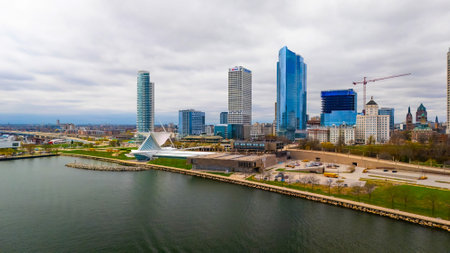 Milwaukee Wisconsin city skyline with modern skyscrapers captured from Lakeshore State Park along Lake Michigan waterfront.の写真素材