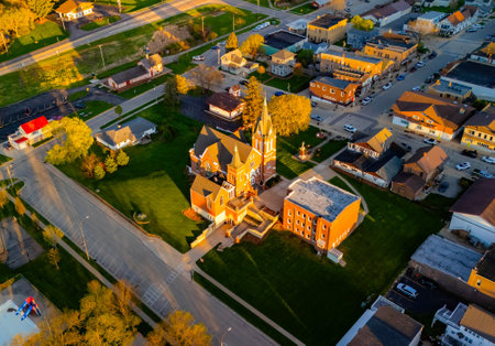 New Glarus Wisconsin at sunset showing city buildings, rooftops, and the Swiss United Church of Christ in golden light.の写真素材