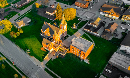 New Glarus Wisconsin at sunset showing city buildings, rooftops, and the Swiss United Church of Christ in golden light.の写真素材