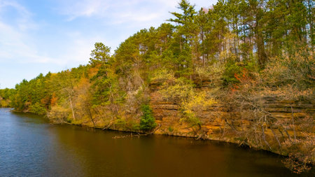 View of Mirror Lake State Park in Wisconsin capturing Echo Rock scenic sandstone cliffs and calm lake reflection from the water.の写真素材