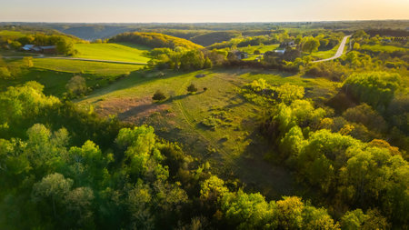 Aerial view from Apple Blossom Overlook Park showing rolling green hills and farmland at sunset with golden light over the rural Wisconsin landscape.の写真素材