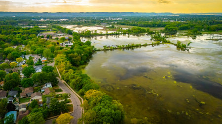 Drone view of residential houses in La Crosse Wisconsin located near marshlands, showing the blend of urban living and natural wetland landscape.の写真素材