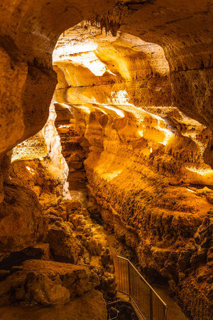 Scenic interior view of Cave of the Mounds in Wisconsin showing illuminated stalactites and stalagmites with dramatic lighting and no people visible.の写真素材