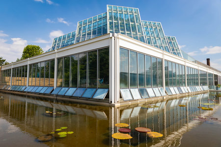 Como Park Conservatory Building under the bright summer sun, surrounded by lush greenery and vibrant botanical gardens in Minnesota