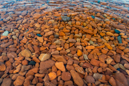 Captivating view of colored rocks and clear waters at Ionas Beach along the shore of Lake Superiorの写真素材