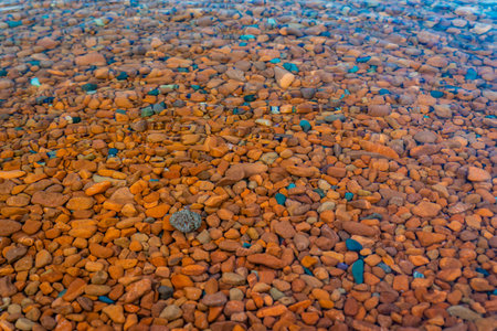Captivating view of colored rocks and clear waters at Ionas Beach along the shore of Lake Superiorの写真素材