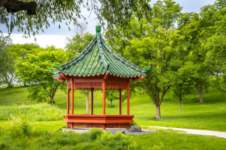 Beautiful chinese garden with red Gazebo on sunny day at Minnesota Landscape Arboretumの写真素材
