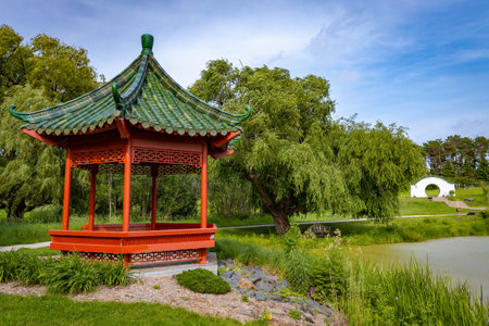 Beautiful chinese garden with red Gazebo on sunny day at Minnesota Landscape Arboretumの写真素材