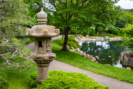 Traditional Japanese stone lantern pagoda stands serene in the beautiful Normandale Japanese Gardenの写真素材