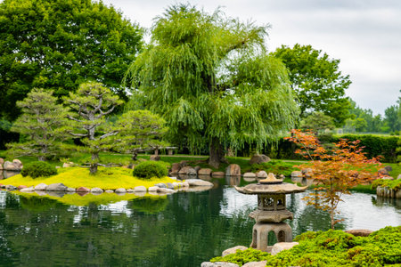 Traditional Japanese stone lantern pagoda stands serene in the beautiful Normandale Japanese Gardenの写真素材