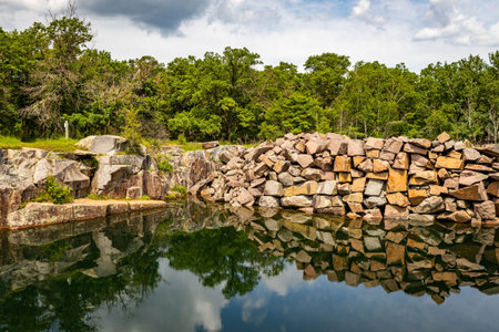 A scenic pond surrounded by rugged rocky stones at Quarry Park and Nature Preserve