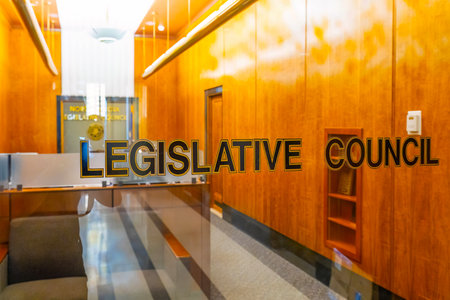 prominent sign for the Legislative Council affixed to modern glass doors
