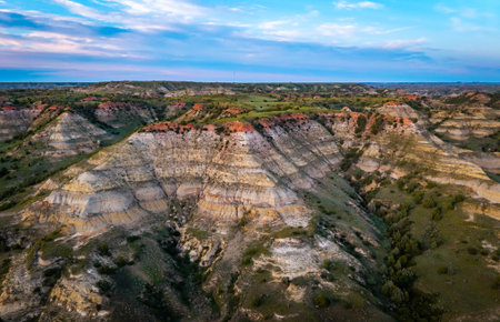 Scenic aerial view near Theodore Roosevelt National Park showcasing colorful Canyons at sunset sunの写真素材