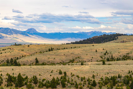 A scenic view captures Montana's majestic mountains stretching across expansive valley plainsの写真素材