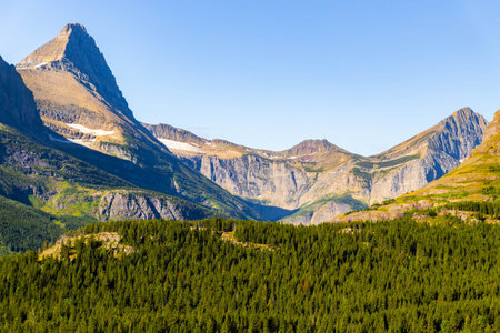 A scenic view captures a majestic mountain range from the Iceberg Lake Trail in Glacier National...