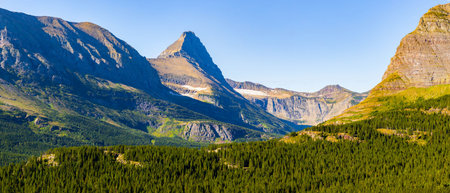 A scenic view captures a majestic mountain range from the Iceberg Lake Trail in Glacier National...