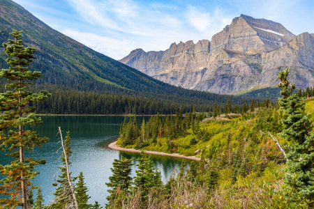 A scenic view of Lake Josephine as seen from the Grinnell Lake Trail in the Many Glacier area.