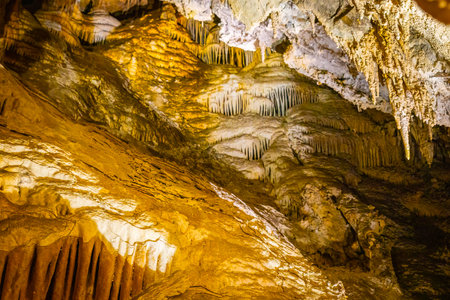 A scenic and illuminated view of the caverns inside Lewis and Clark Caverns State Park is captured, highlighting the stunning geological formations and the unique lighting that enhances their beautyの写真素材