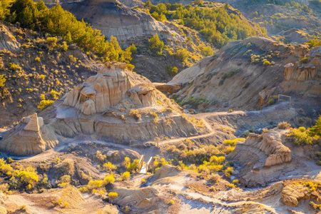 A dramatic sunset over the badlands formations of Makoshika State Park as seen from the Cap Rock Trailの写真素材