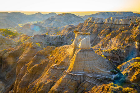 A dramatic sunset over the badlands formations of Makoshika State Park as seen from the Cap Rock Trailの写真素材