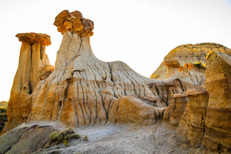 The iconic Twin Sisters rock formation silhouetted against a beautiful sunset sky at Makoshika State Parkの写真素材