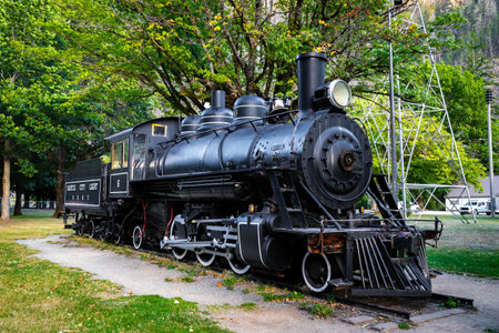 Newhalem, WA, USA - September 12, 2025: Scenic Newhalem Main Street with historic locomotive...