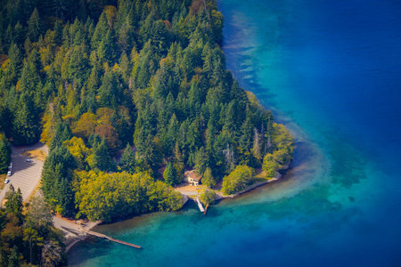 A stunning panoramic view captures the pristine Lake Crescent stretching out below, seen from the...