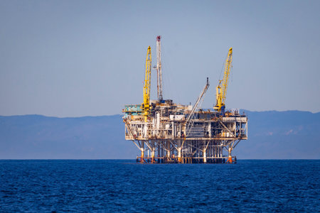 Offshore oil platform operating at sea extracting petroleum resources for global energy and...