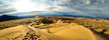 Panoramic view from the top shows Kelso Dunes at sunset in the Mojave Desert California