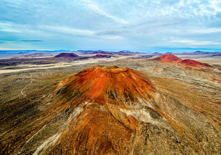 Aerial view shows cinder cone volcanoes at sunset in the Mojave Desert California