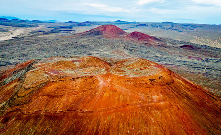 Aerial view shows cinder cone volcanoes at sunset in the Mojave Desert California