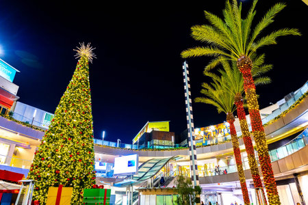 Los Angeles, CA, USA - December 01, 2025: Festive holiday display glows within the modern outdoor...
