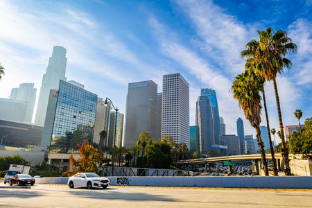 Los Angeles, CA, USA - December 03, 2025: Vehicles move along busy city streets beneath towering downtown office buildingsのeditorial素材