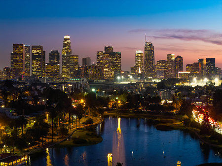 Los Angeles, CA, USA - December 18, 2025: Aerial view shows Los Angeles skyscrapers illuminated at night from Echo Park Lake in Californiaのeditorial素材