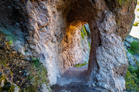 Scenic hiking trail through Pinnacles National Park California with panoramic mountain and rock formation views on a sunny dayの写真素材