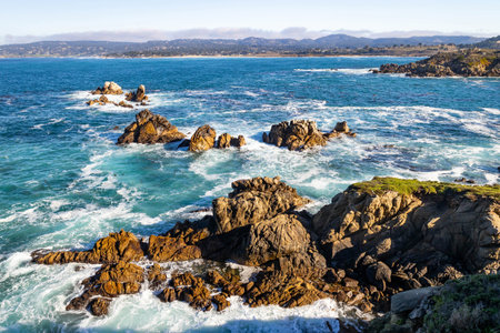 Pacific Ocean waves strike rugged coastal cliffs at Point Lobos State Natural Reserve in California