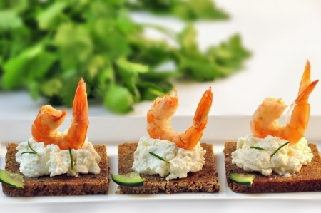 canapes rye bread with ricotta cheese and shrimpsの写真素材