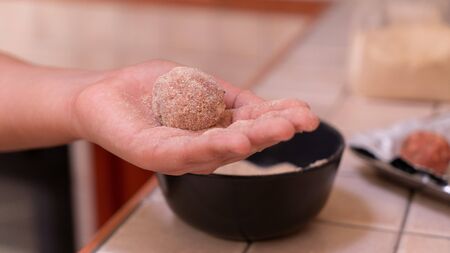 raw beef meatball on the hand