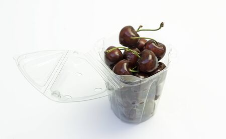 cherries in a recycled plastic bowlの写真素材